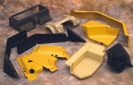 collage of yellow and black plastic parts for vehicle trim