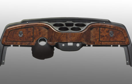 dashboard with dark gray top and bottom with drink holders and brown patterned glossy front with compartments